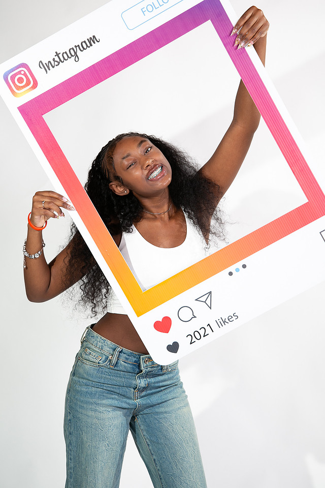 Guest holding a colorful Instagram-style photo frame prop
